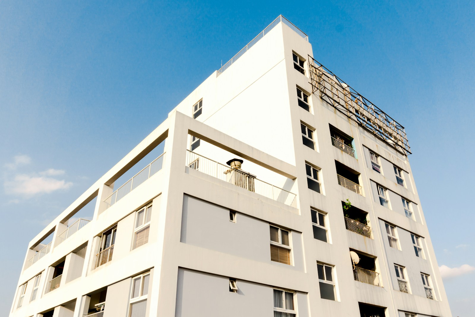 white concrete building with commercial property insurance under blue sky during daytime