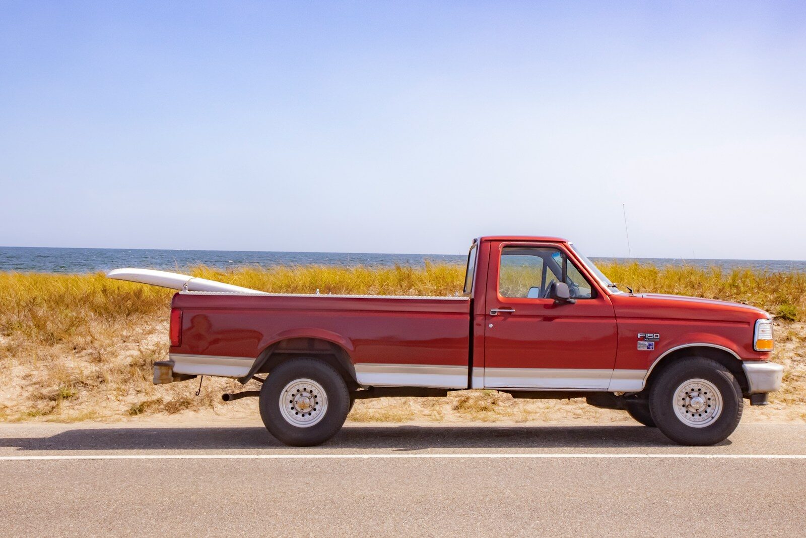brown crew cab pickup truck on road during daytime